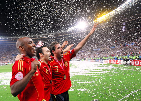 (From L) Spanish midfielders Marcos Senna and Andres Iniesta and defender Fernando Navarro celebrate with supporters after winning the Euro 2008 championships final football match over Germany on June 29, 2008 at Ernst-Happel stadium in Vienna, Austria. Spain ended their 44-year wait for a major international title with a 1-0 victory over Germany at the Euro 2008 final. AFP PHOTO / JOE KLAMAR -- MOBILE SERVICES OUT -- (Photo credit should read JOE KLAMAR/AFP/Getty Images)