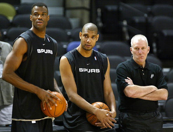 David Robinson (L) Tim Duncan (C) and head coach Gregg Popovich (R) of the San Antonio Spurs watch the rest of their team practice for the NBA finals 05 June, 2003 at the SBC Center in San Antonio, Texas. The Spurs beat the New Jersey Nets in game one 04 June 2003 to lead the best-of seven game series 1-0. AFP PHOTO/Jeff HAYNES (Photo credit should read JEFF HAYNES/AFP/Getty Images)