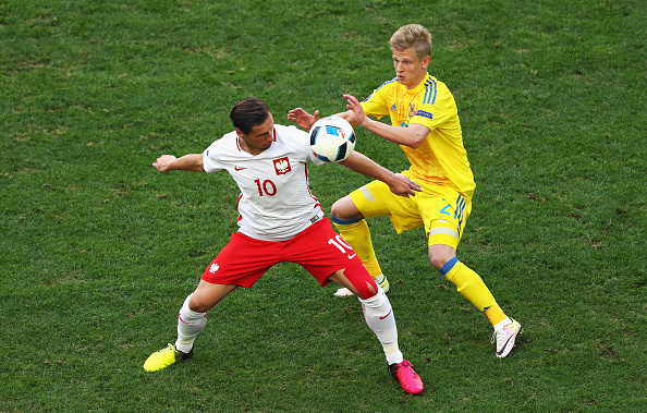 MARSEILLE, FRANCE - JUNE 21:  Grzegorz Krychowiak of Poland is tackled by Olexandr Zinchenko of Ukraine during the UEFA EURO 2016 Group C match between Ukraine and Poland at Stade Velodrome on June 21, 2016 in Marseille, France.  (Photo by Lars Baron/Getty Images)